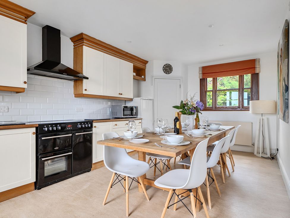 A kitchen with a dining table and chairs at Cragford in Sennen Cove