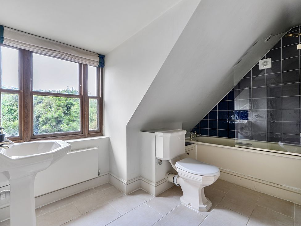 A bathroom with a sink, toilet, and bathtub at Cragford in Sennen Cove