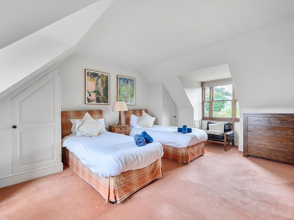 A bedroom with two beds and a dresser at Cragford in Sennen Cove