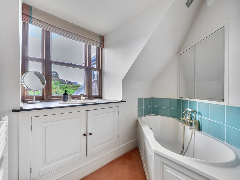 A bathroom with a bathtub and a sink at Cragford in Sennen Cove
