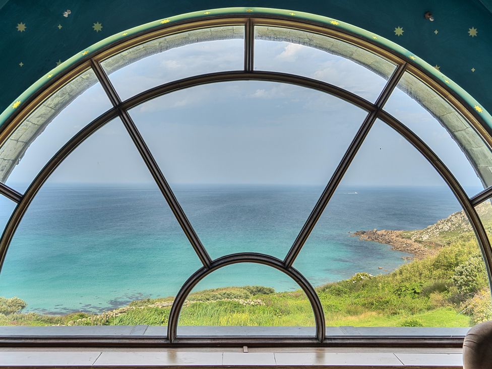 A view of the sea through a large window at Cragford in Sennen Cove