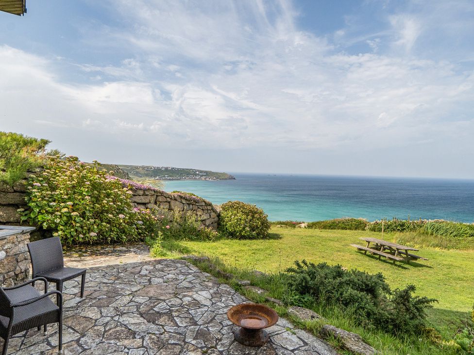 A patio with garden and sea view at Cragford Sennen Cove