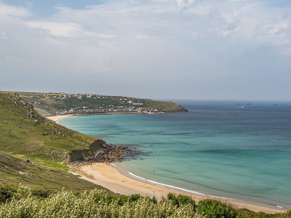 A beach with sand and water at Cragford in Sennen Cove