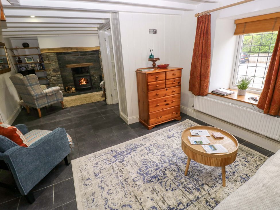 A living room with furniture and a fireplace at Milk Wood Cottage in Laugharne