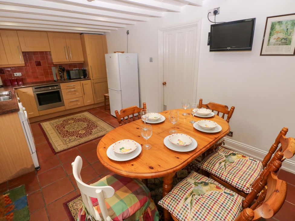 A dining area with a table and chairs at Milk Wood Cottage in Laugharne