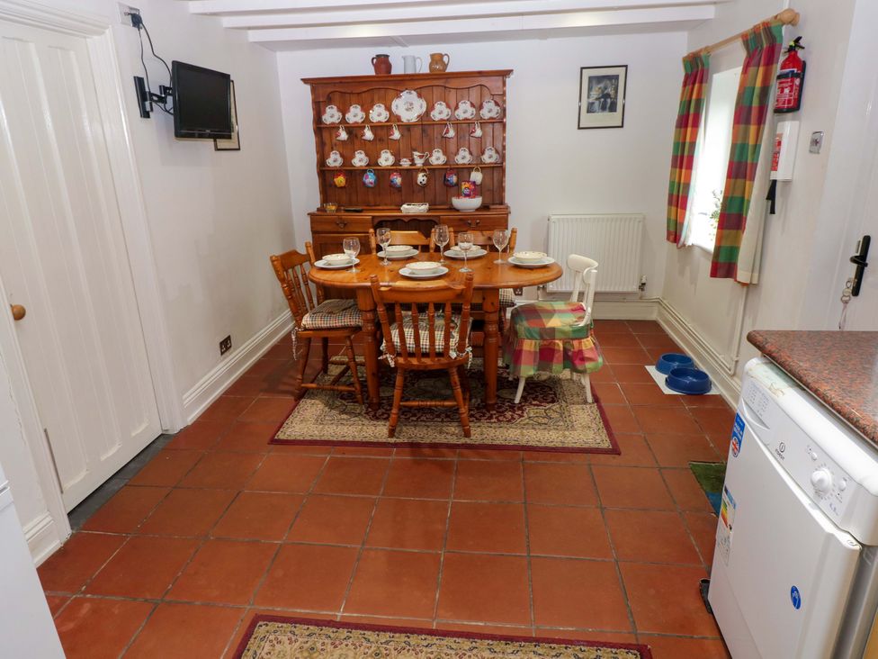 A dining room with a table and chairs at Milk Wood Cottage in Laugharne