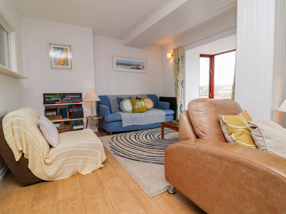 A living room with sofa and armchair at The Fort in Bude