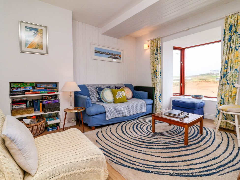 A living room with furniture and a window at The Fort in Bude