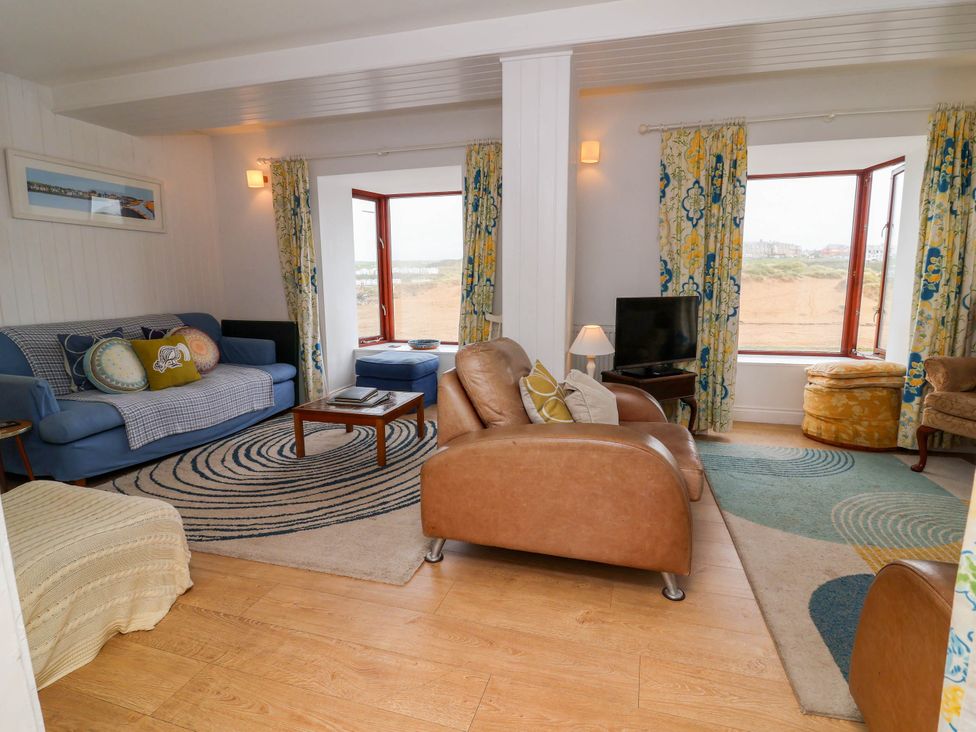 A living room with a sofa and coffee table at The Fort in Bude