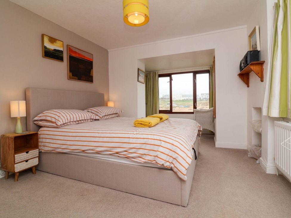 A bedroom with a bed and window at The Fort in Bude