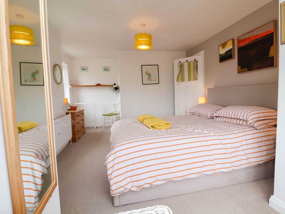 A bedroom with a bed and decorative items at The Fort in Bude