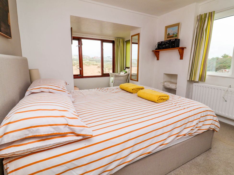 A bedroom with a bed and yellow towels at The Fort in Bude
