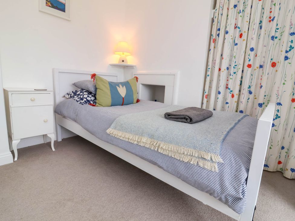 A bedroom with a bed and nightstand at The Fort in Bude