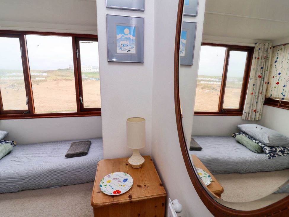 A bedroom with a bed and lamp at The Fort in Bude