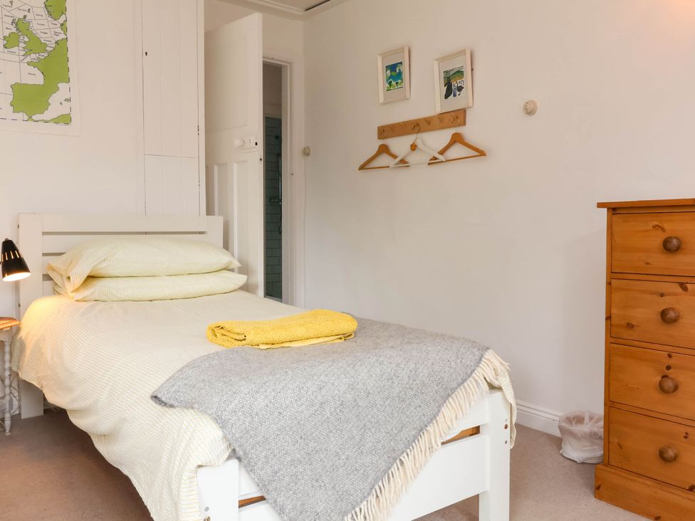 A bedroom with a bed and a chest of drawers at The Fort in Bude