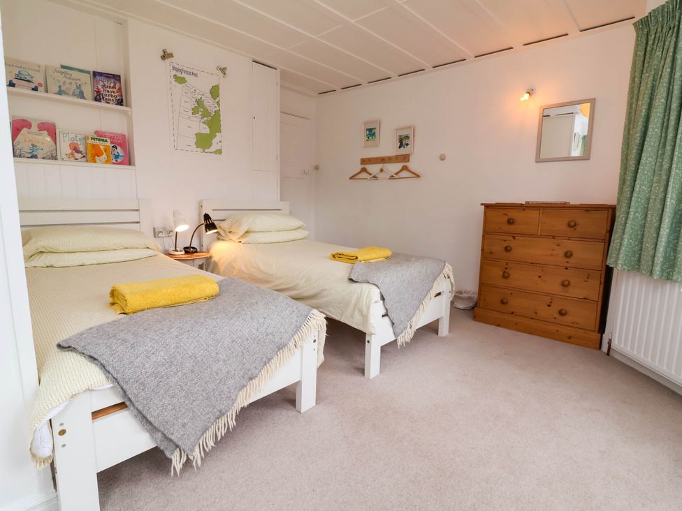A bedroom with two beds and a dresser at The Fort in Bude