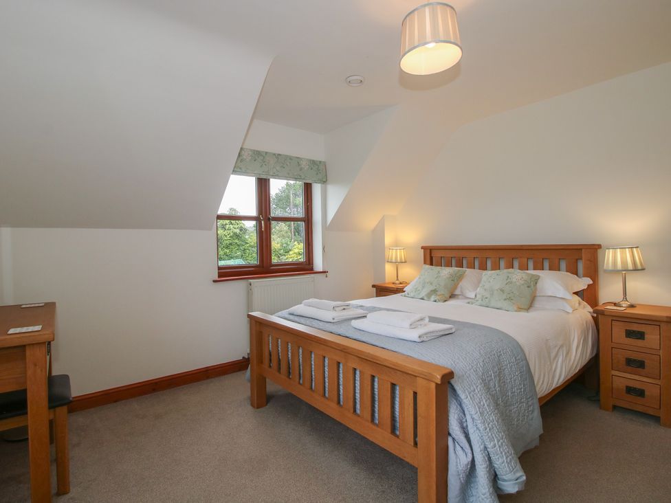 A bedroom with a bed and desk at Byne Brook Cottage Strefford near Craven Arms