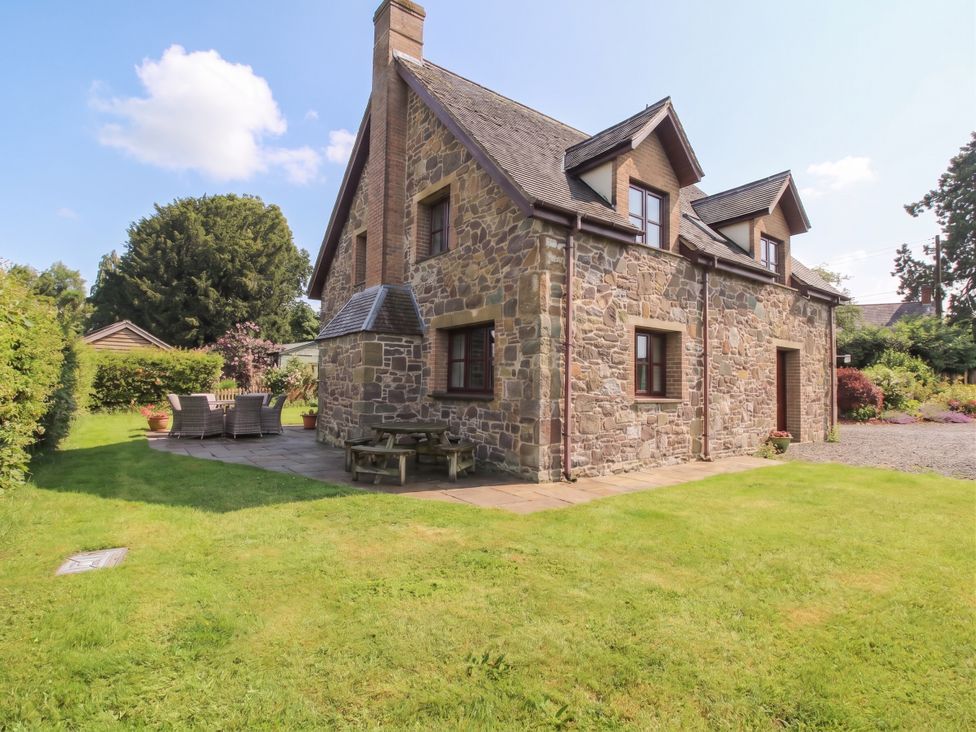A house with a garden and seating area at Byne Brook Cottage Strefford near Craven Arms