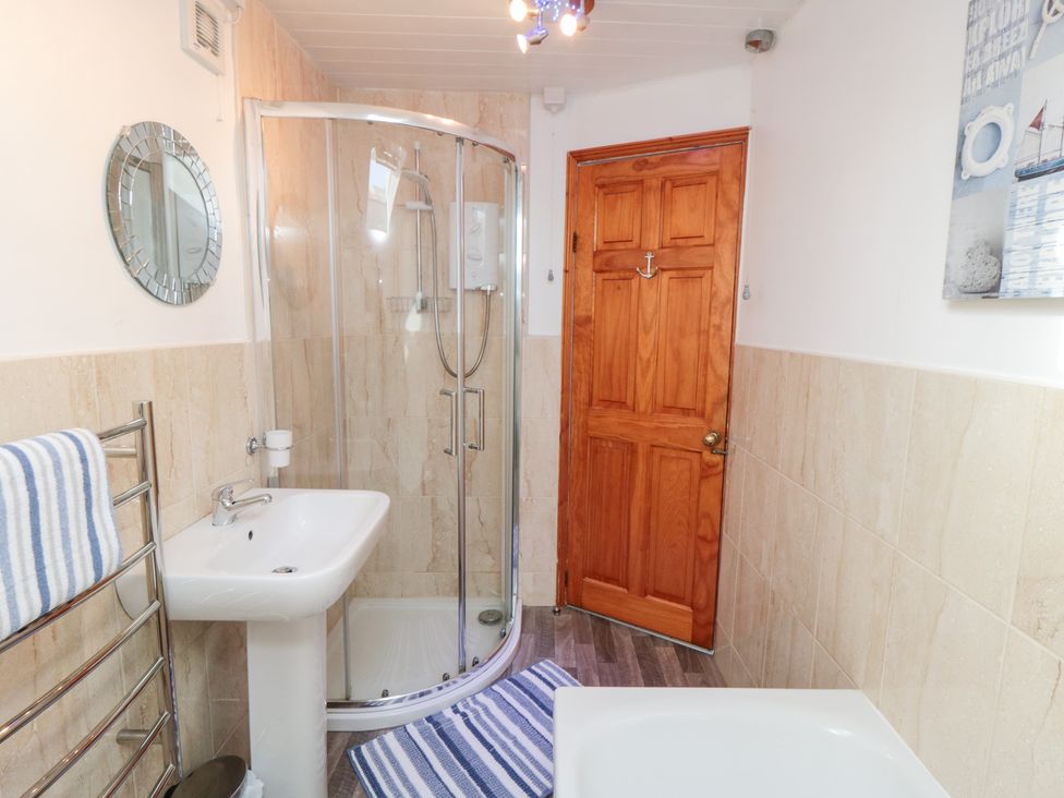 A bathroom with a shower and sink at Fairhaven Cottage Ugthorpe near Runswick Bay