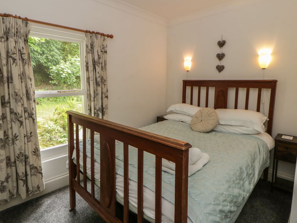 A bedroom with a bed and window at Teifi House in Cilgerran near Cardigan