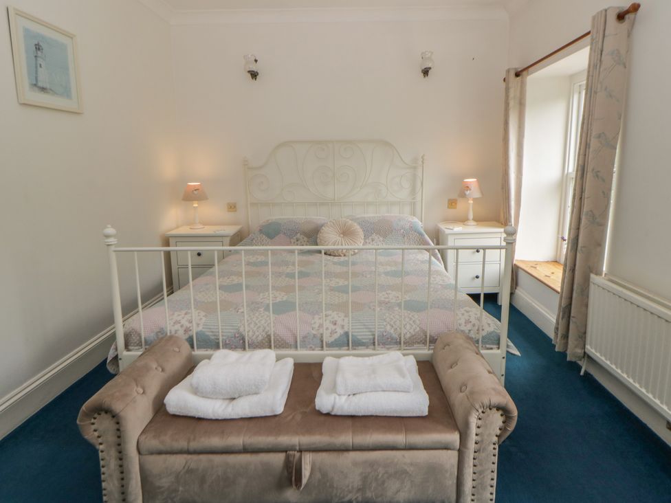 A bedroom with a bed and bench at Teifi House in Cilgerran near Cardigan