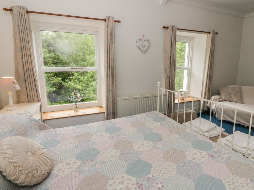 A bedroom with a bed and window at Teifi House in Cilgerran near Cardigan