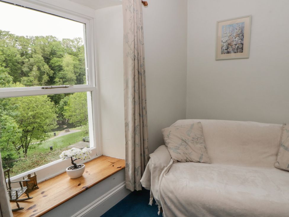 A living room with a sofa near a window at Teifi House in Cilgerran near Cardigan