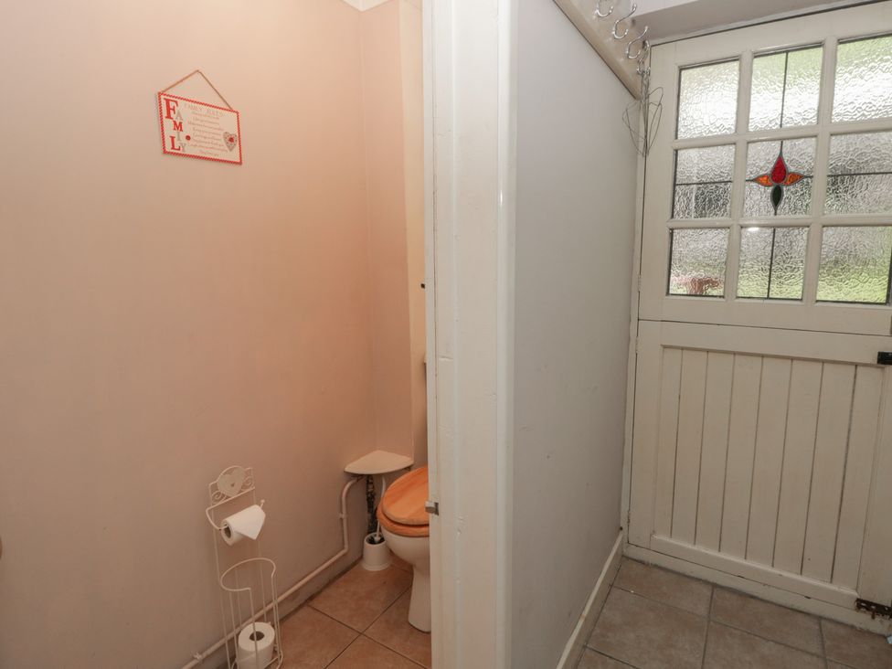 A bathroom with a toilet and coathooks at Teifi House in Cilgerran near Cardigan