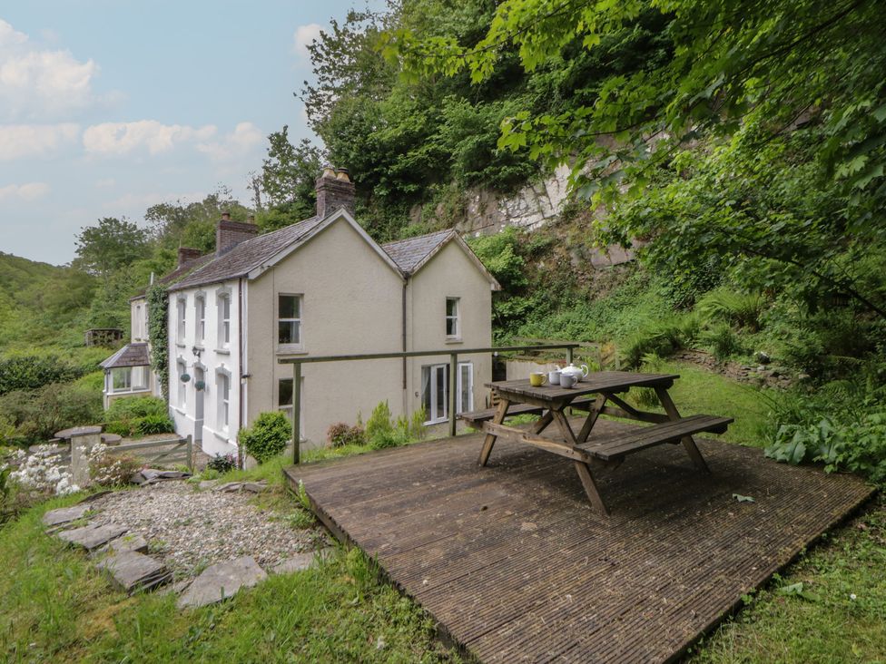 A house with a deck and outdoor seating area at Teifi House, Cilgerran near Cardigan