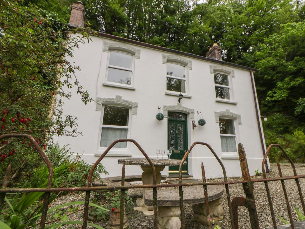 A house with windows and a door in a garden at Teifi House in Cilgerran near Cardigan