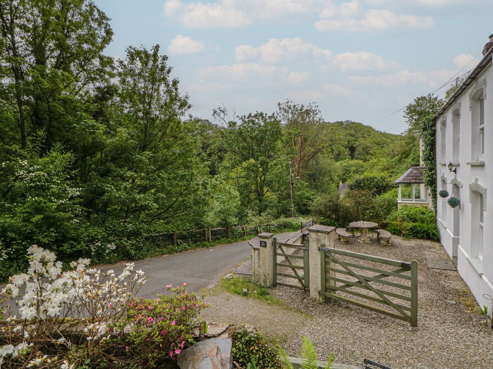 A garden area with a gate and seating at Teifi House in Cilgerran near Cardigan