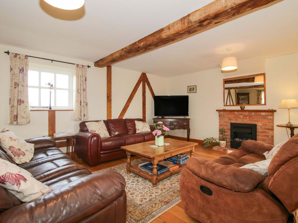 A living room with a tv and a coffee table at The Barn in Cockshutt near Ellesmere