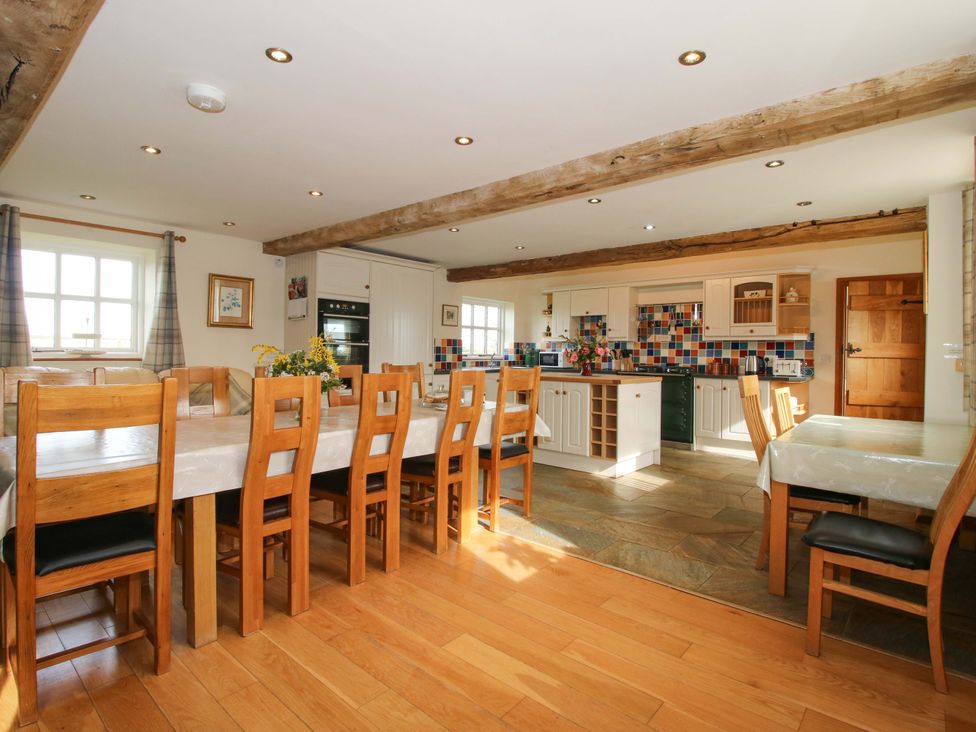 A kitchen with a dining area and an island at The Barn Cockshutt near Ellesmere