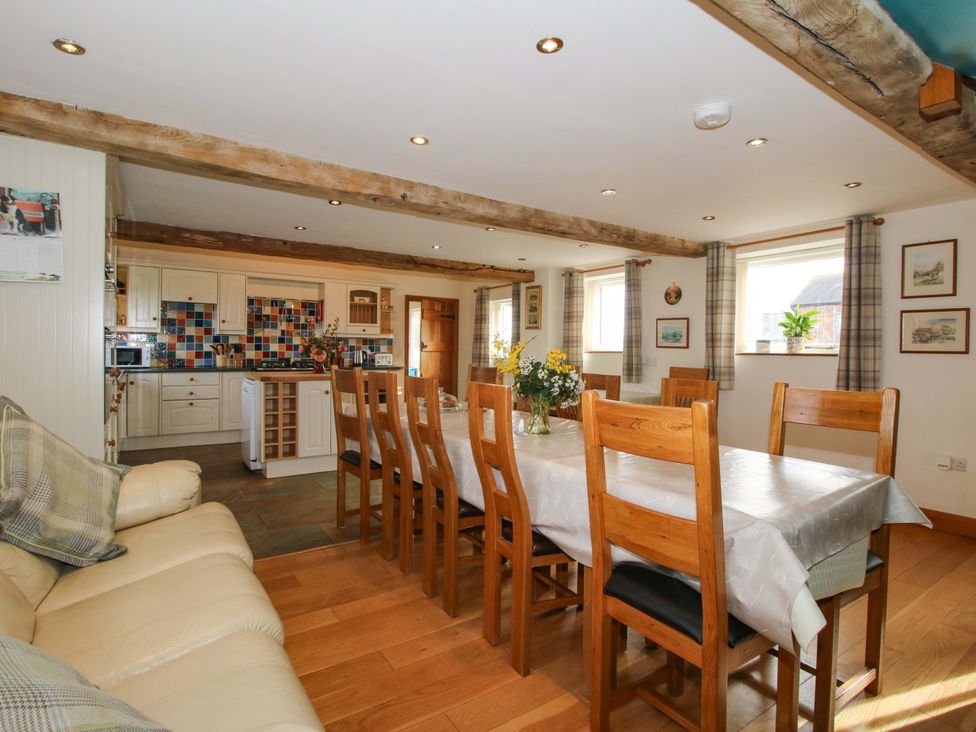 A kitchen with a dining table and chairs at The Barn Cockshutt near Ellesmere