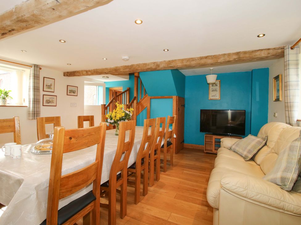 A dining room with a table and chairs at The Barn in Cockshutt near Ellesmere