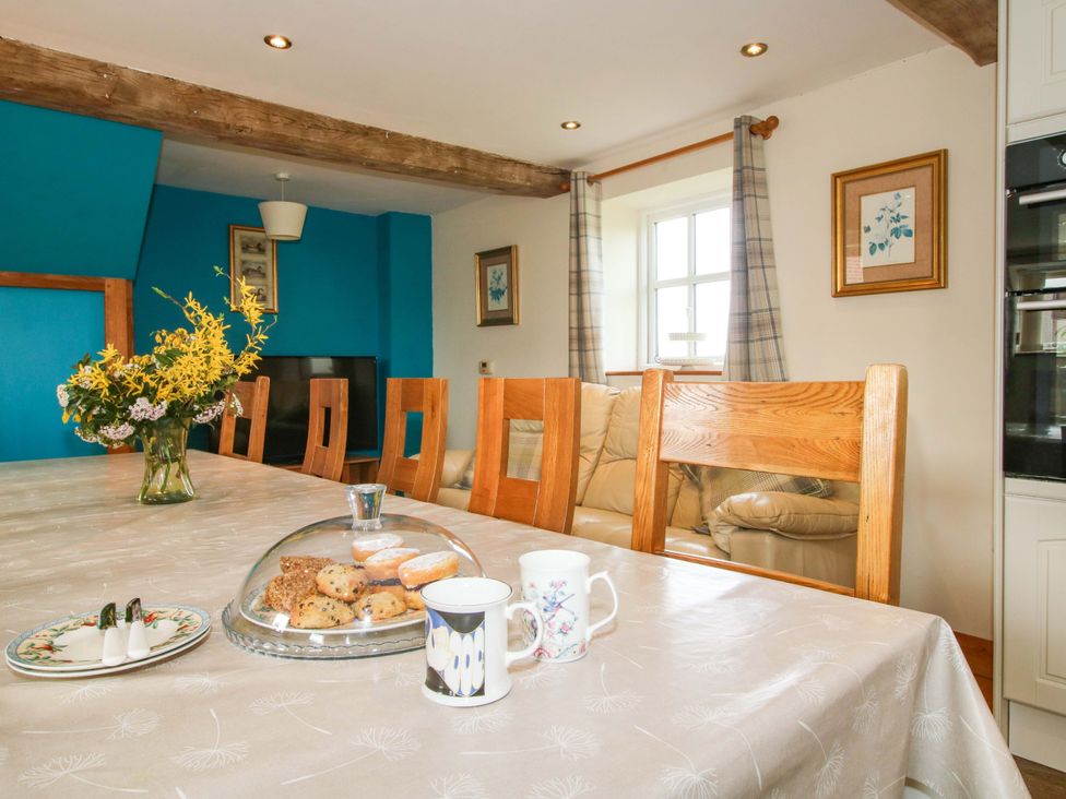A dining room with a table and chairs at The Barn in Cockshutt near Ellesmere