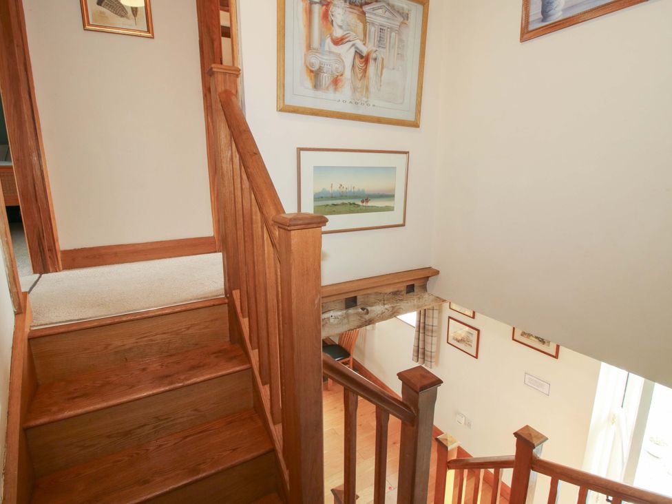 A staircase leading to a hallway at The Barn Cockshutt near Ellesmere