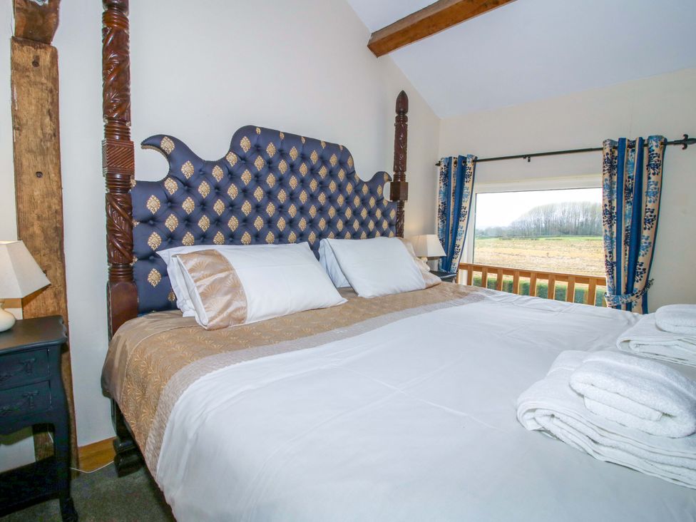 A bedroom with a bed and window at The Barn Cockshutt near Ellesmere