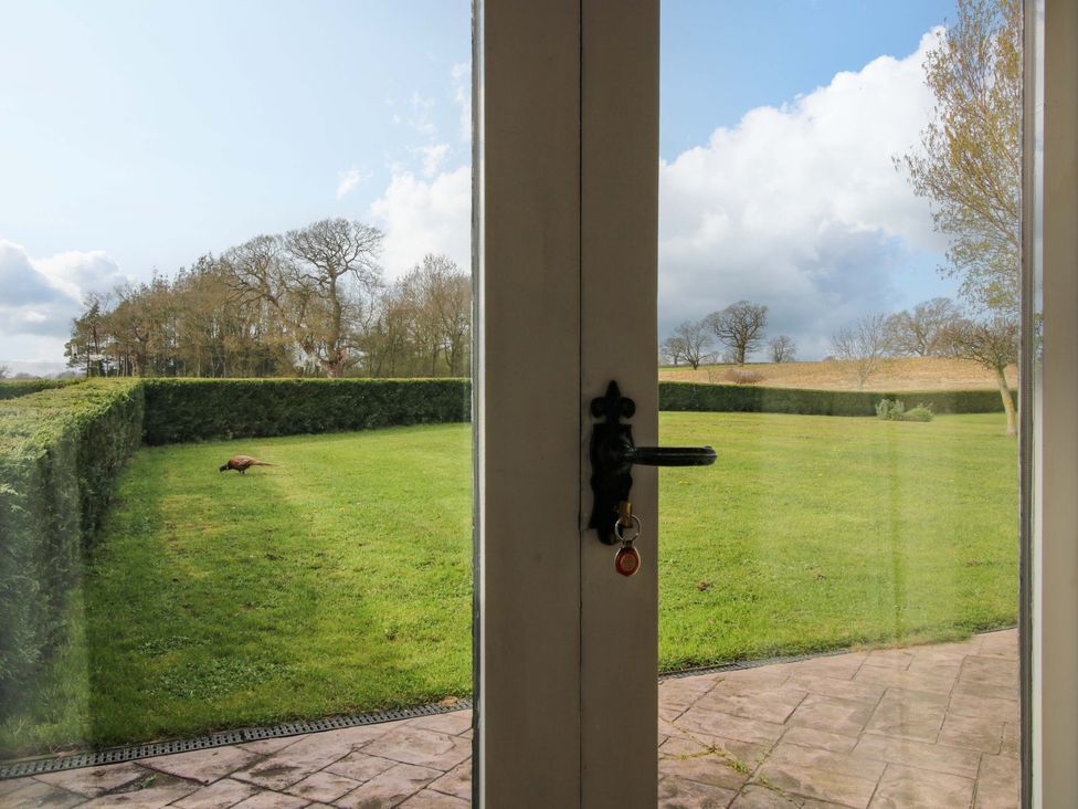 A view of the garden through a door at The Barn Cockshutt near Ellesmere