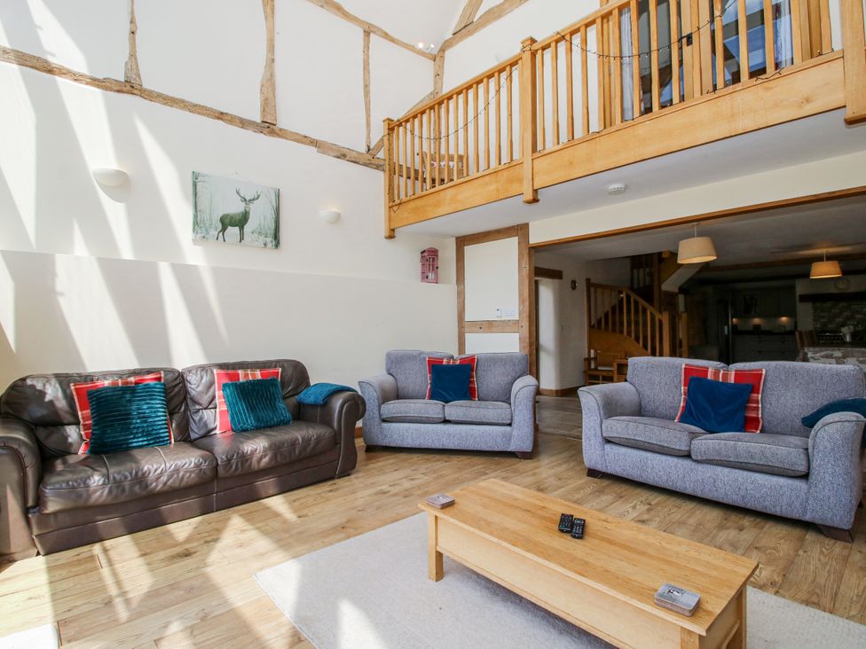 A living room with sofas and a coffee table at The Hayloft in Bleddfa near Knighton