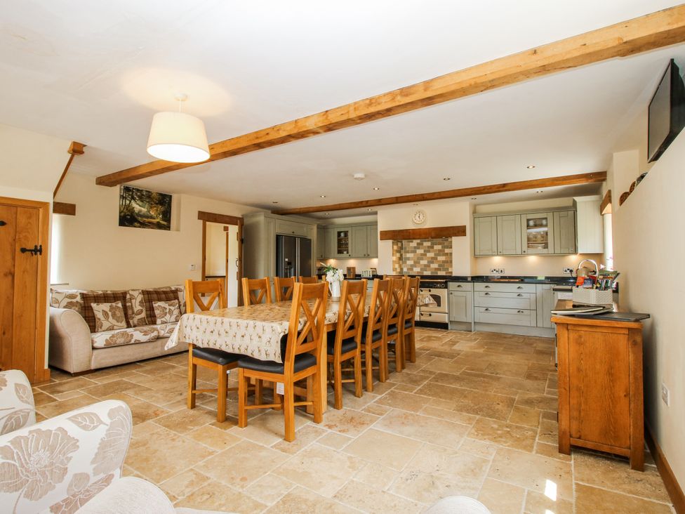 A dining room with a table and chairs at The Hayloft in Bleddfa near Knighton