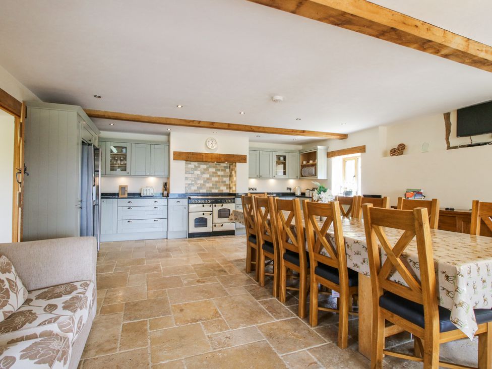 A kitchen with a dining table and chairs at The Hayloft in Bleddfa near Knighton
