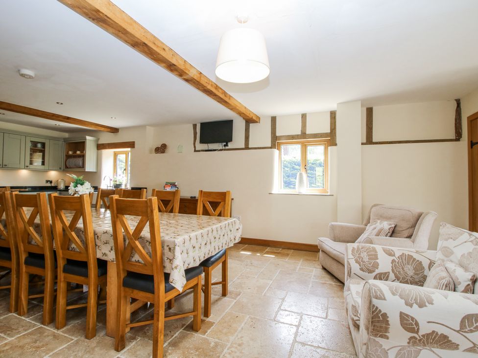 A dining room with a table and chairs at The Hayloft in Bleddfa near Knighton