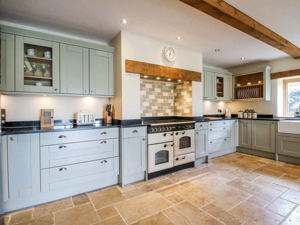 A kitchen with cabinets and appliances at The Hayloft in Bleddfa near Knighton