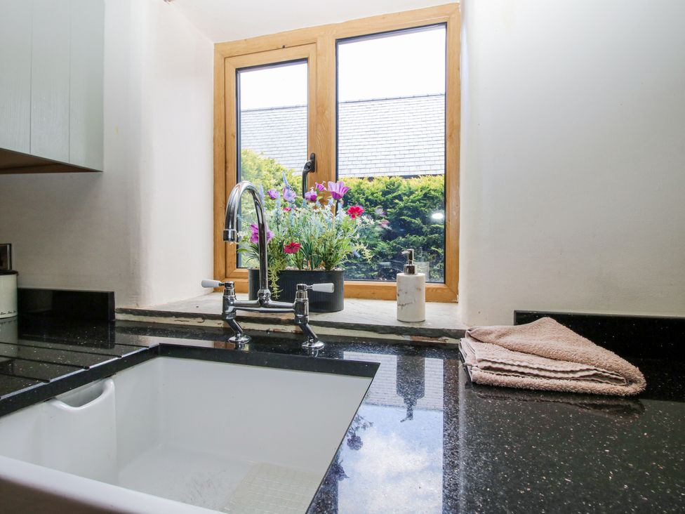 A kitchen with a sink and window at The Hayloft in Bleddfa near Knighton