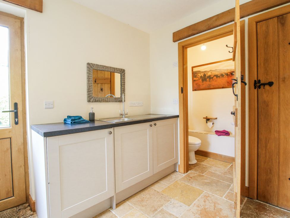 A bathroom with a mirror and sink at The Hayloft in Bleddfa near Knighton