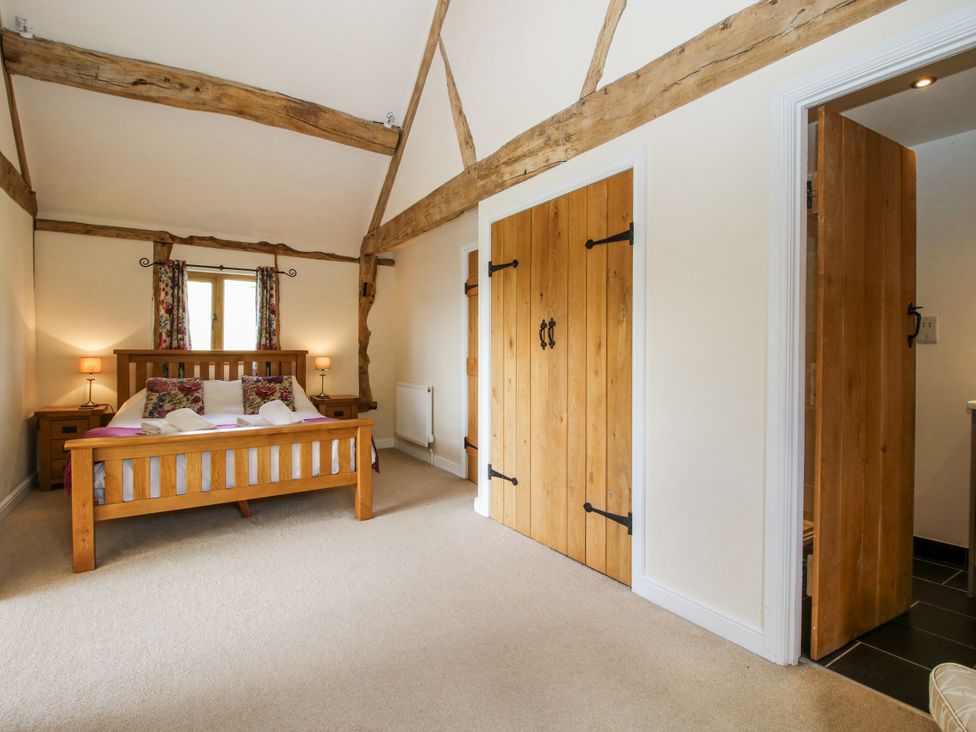 A bedroom with a bed and nightstands at The Hayloft in Bleddfa near Knighton