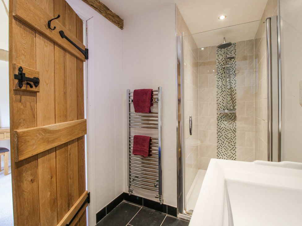 A bathroom with a shower and towel rack at The Hayloft in Bleddfa near Knighton