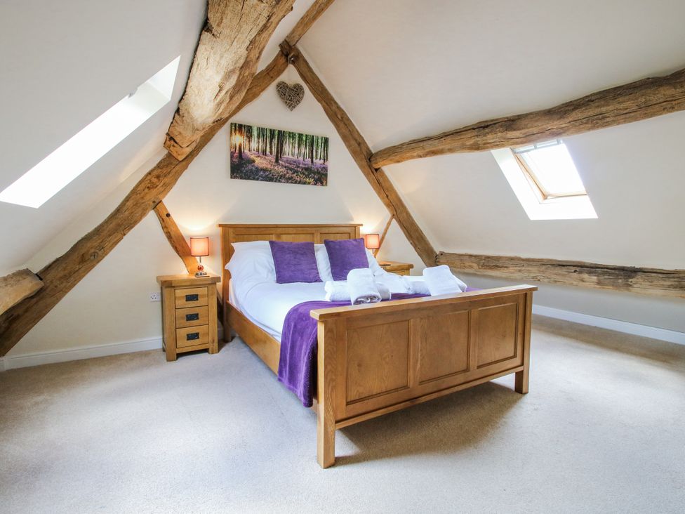 A bedroom with wooden beams and a double bed at The Hayloft in Bleddfa near Knighton