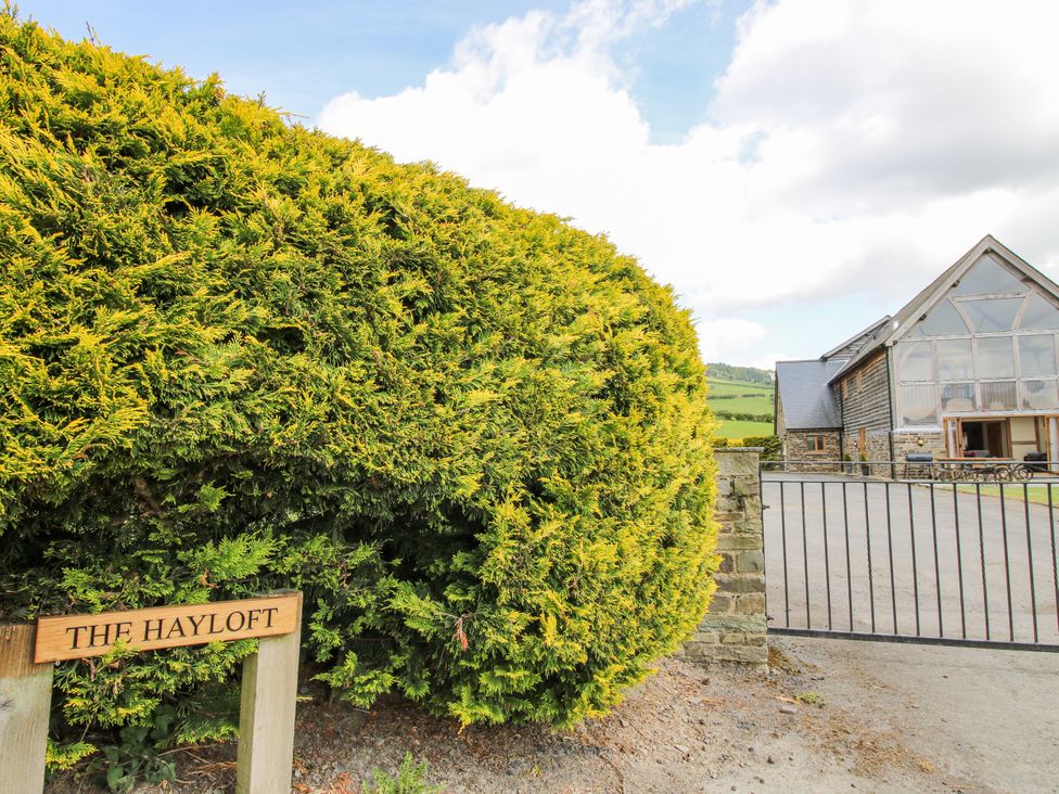 An outdoor view of The Hayloft and sign in Bleddfa near Knighton
